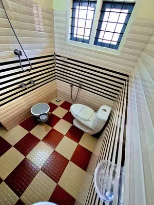 a bathroom with a shower and a toilet in it at Wayanad Pent House in Mananthavady