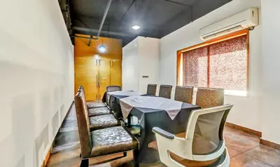 a dining room with a table and chairs at Medora Hotel by Rak Rooms in Kozhikode