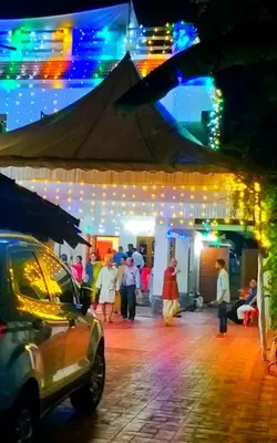 a group of people walking on a street at night at Grace Guest Home in Trichūr