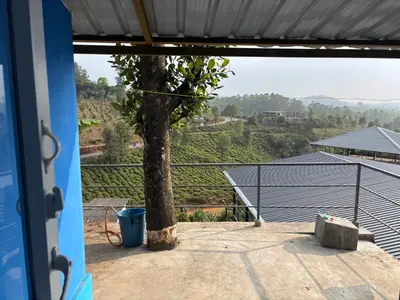 a view from the outside of a house with a tree at The Retreat in Vālpārai