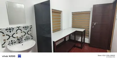 a bathroom with a sink and a mirror at Pranavam homestay in Guruvāyūr
