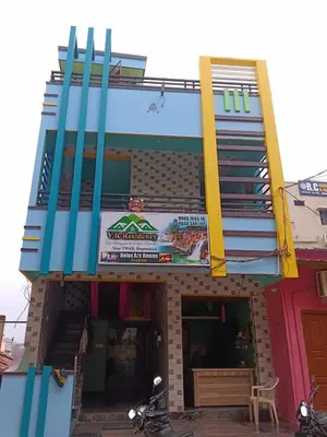 a building with a balcony with a sign on it at VR Residency in Wodapatti