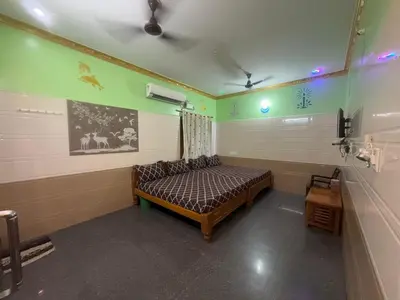 a room with a bed in the corner of a room at VR Residency in Wodapatti