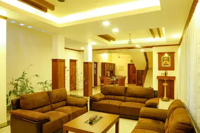 a living room with two couches and a table at River Whisper Homestay in Cochin