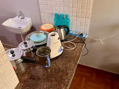 a counter top with a sink and a blender and a sink at Bean & Breeze in Suntikoppa