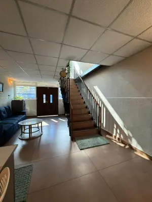 a living room with a staircase and a table at Oblue Private Pool Villa in Cherai Beach