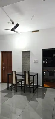 a dining room with a table and chairs at Love Nest Inn Homestay in Agali
