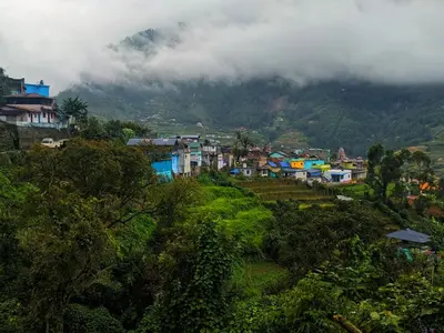 a group of houses in a village on a mountain at Brooklyn Homestay in Vattavada