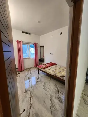 a room with a bed and a marble floor at Brooklyn Homestay in Vattavada