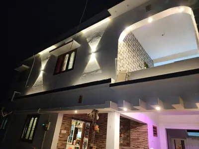 a building with a large mirror on the side of it at Brooklyn Homestay in Vattavada