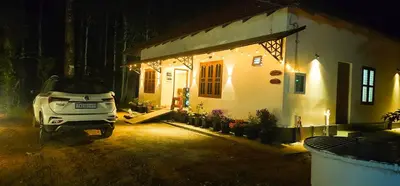 a car parked in front of a house at night at Mamoksha Riverdale in Padinjarathara