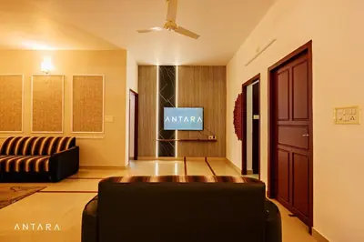 a living room with a couch and a tv at Antara Luxury Homestay in Alwaye