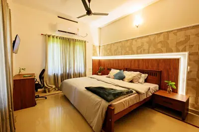 a bedroom with a large bed in a room at Antara Luxury Homestay in Alwaye