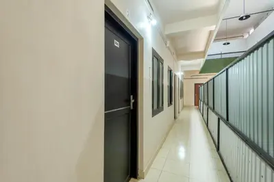 a hallway with a black door in a building at Grape Rooms in Perintalmanna