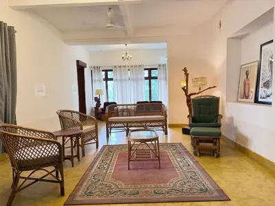 a living room with chairs and a table at Himalaya - 6bh Bunglow in Mysore