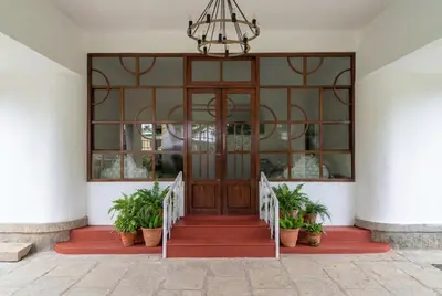 a front door of a house with potted plants at Himalaya - 6bh Bunglow in Mysore