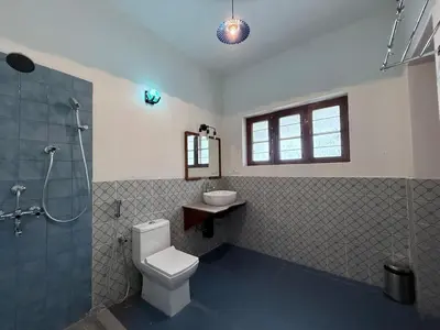 a bathroom with a toilet and a shower and a sink at Himalaya - 6bh Bunglow in Mysore