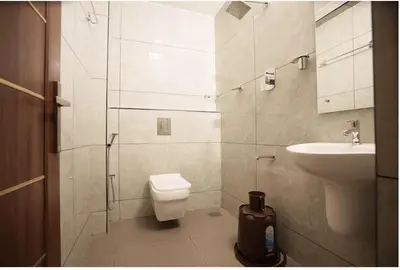 a bathroom with a toilet and a sink at Kanak Residency in Green Island