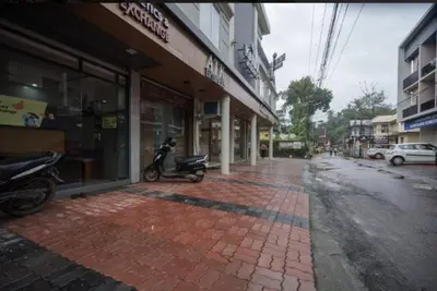 a moped parked on a brick sidewalk in front of a building at Kanak Residency in Green Island