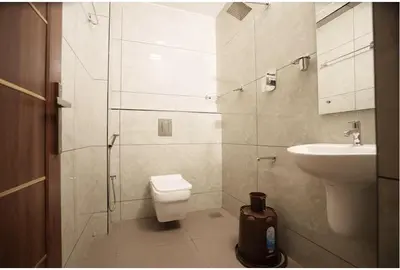a bathroom with a toilet and a sink at Kanak Residency in Green Island