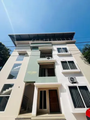a white building with many windows on it at City Creek in Perintalmanna