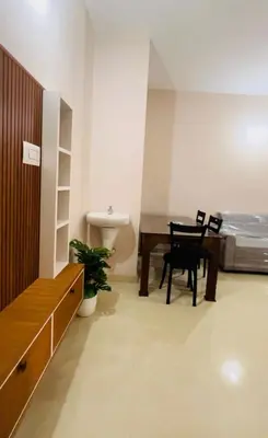 a room with a table and chairs and a bed at City Creek in Perintalmanna