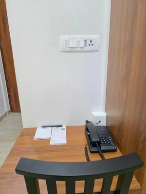 a desk with a phone sitting on top of it at Dream wagon hotel lakkidi in Vythiri