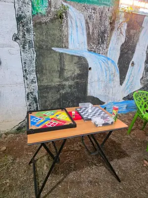 a table with a painting on it in front of a wall at Dream wagon hotel lakkidi in Vythiri