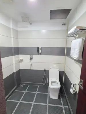 a small bathroom with a toilet in a stall at Dream wagon hotel lakkidi in Vythiri