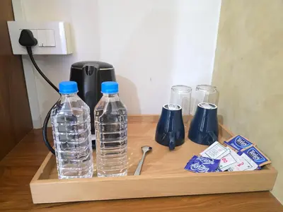 a wooden shelf with two bottles of water and other items at Dream wagon hotel lakkidi in Vythiri