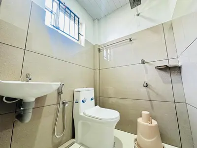 a bathroom with a toilet and a sink at Nila Inn Calicut Near Hilite Mall in Kozhikode