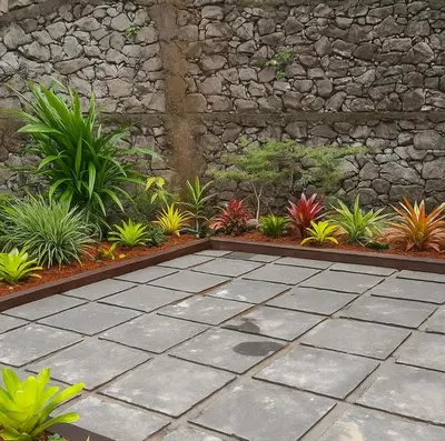 a garden with plants and a stone wall at Skygarden Resort Vythiri in Vythiri