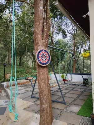 a sign on a tree with a swing at Skygarden Resort Vythiri in Vythiri