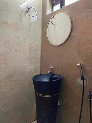 a bathroom with a trash can and a mirror at Skygarden Resort Vythiri in Vythiri