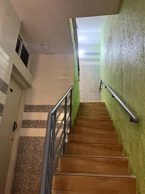 a staircase in a building with green walls at Hotel ZB comforts MYSORE in Mysore