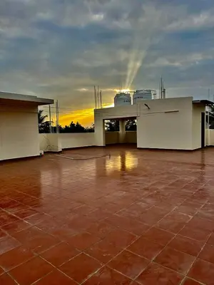 a view of a building with a sunset in the background at Dakshima Residency in Mysore