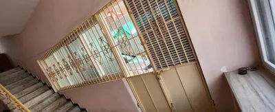 a staircase in a room with a window and a staircase at Deepam Homestay in Coimbatore