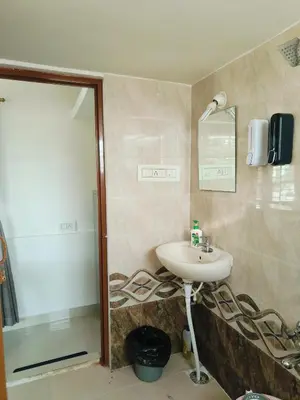 a bathroom with a sink and a shower at Āsare attic in Mysore