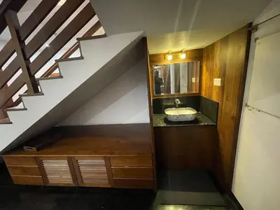 a bathroom with a sink and a staircase at Heritage Home in Ernakulam North Paravur in Ernakulam