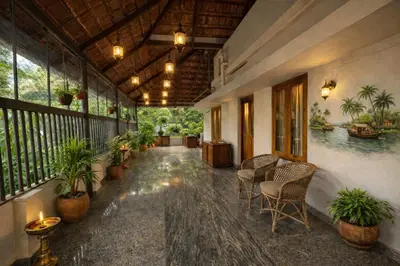 a hallway with chairs and plants in a building at Heritage Home in Ernakulam North Paravur in Ernakulam
