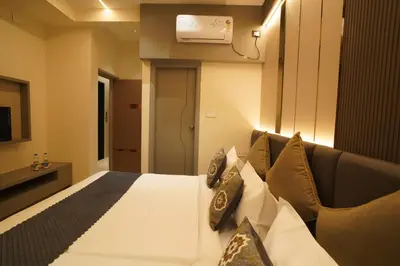a hotel room with a bed and a couch at The Grand Sarayu in Mysore