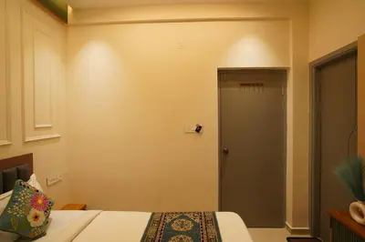 a small room with a bed and a door at The Grand Sarayu in Mysore