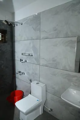 a bathroom with a white toilet and a sink at Brand new 4 BHK luxury villa near kochi airport in Nedumbassery