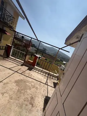 a view from the balcony of a house with a gate at KINGS Home Stay in Ooty