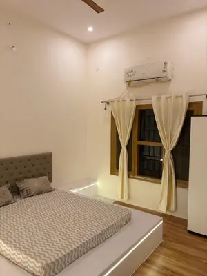 a bedroom with a bed and a window at Sunset Villa Dusk looks better from here in Mysore