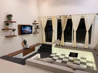 a living room with a couch and a window at Sunset Villa Dusk looks better from here in Mysore