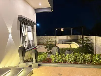 a night view of a garden with a building at Sunset Villa Dusk looks better from here in Mysore
