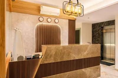 a lobby with a mirror and a reception desk at Hotel Hycon in Kozhikode