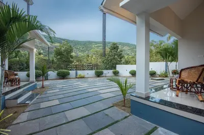 a patio with a view of a mountain at New Abrigo Resorts in Perintalmanna
