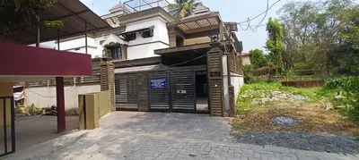 a house with a garage in front of it at Majestic Mirage Service Villa in Kalpetta